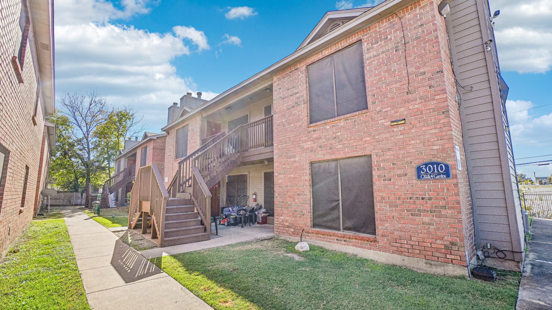 the apartment complex has a large grassy area at The Chalk Gardens