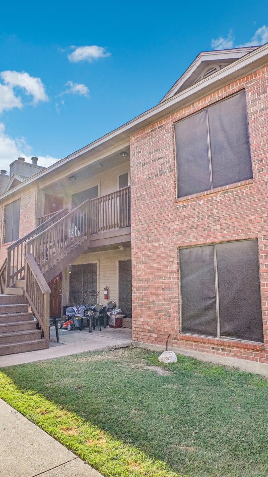 the apartment complex has a large grassy area at The Chalk Gardens
