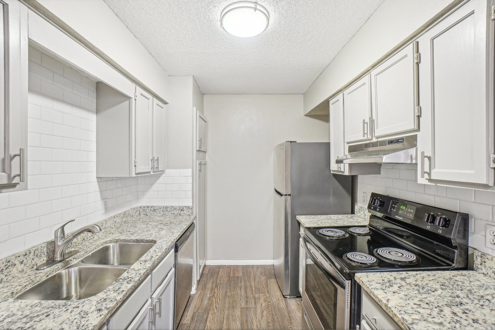 kitchen with granite counter tops and stainless steel appliances at The Chalk Gardens