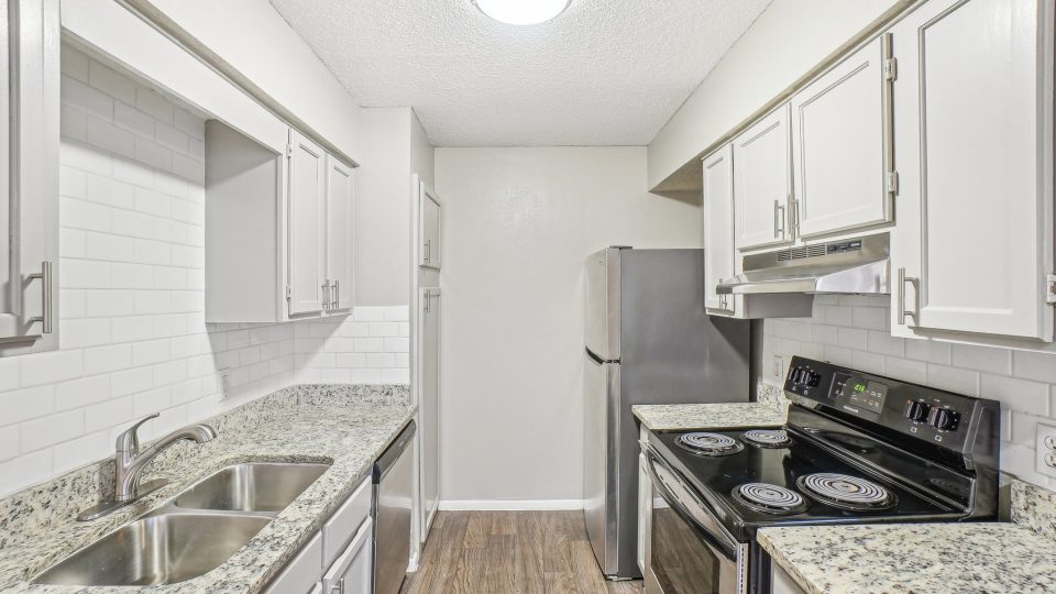 kitchen with granite counter tops and stainless steel appliances at The Chalk Gardens