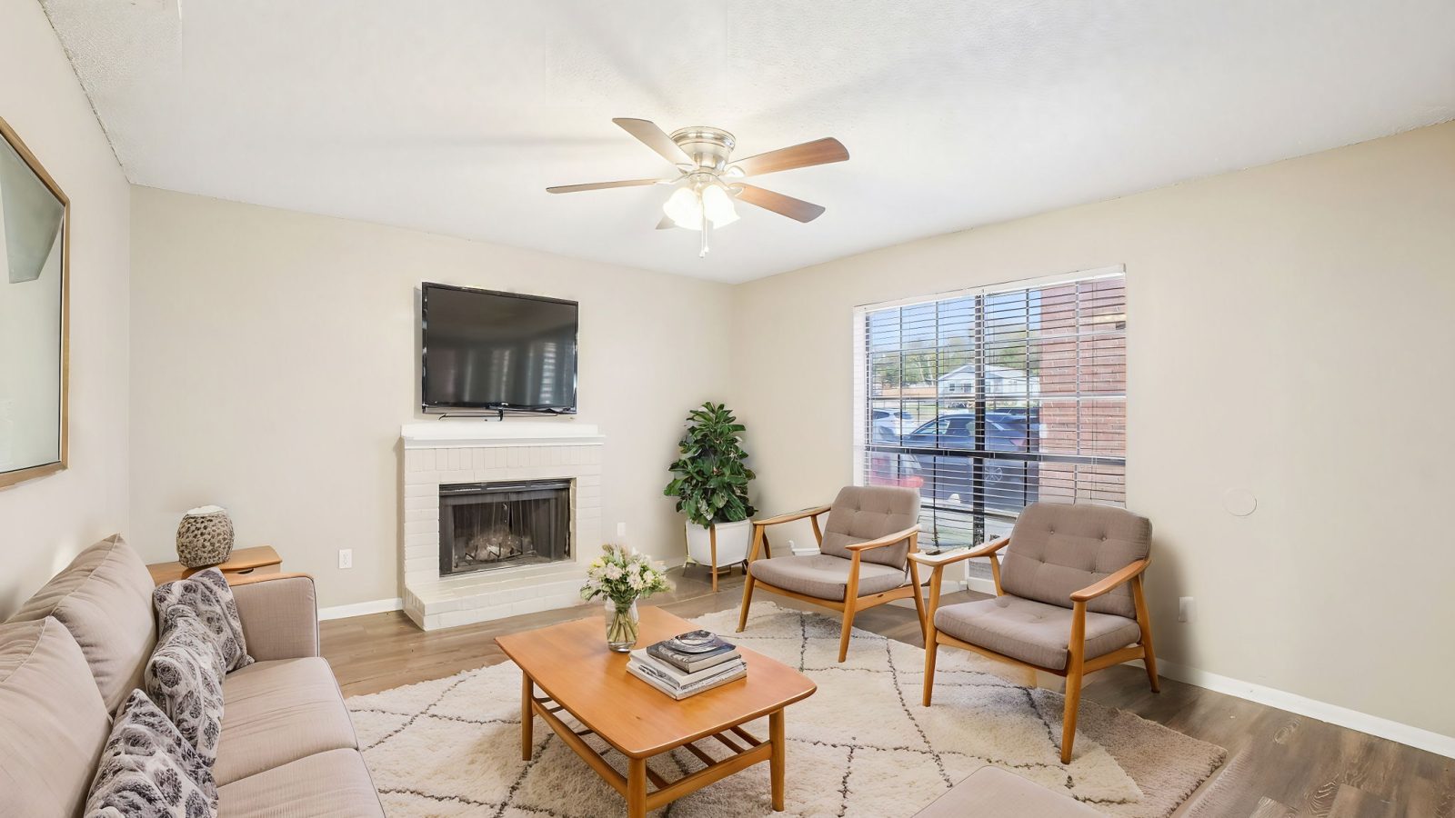 living room with fireplace and ceiling fan at The Chalk Gardens